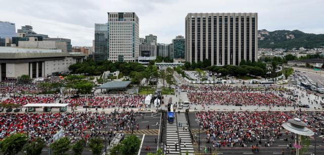 Supporters, including members of the Red Devils, South Korea's official football supporters' group, react with disappointment as they watch the second half of the Group A match between South Korea and South Africa during a public viewing event for the 2026 FIFA World Cup at Gwanghwamun Square in Seoul on June 25, 2026. AJP Yoo Na-hyun.
