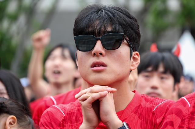 Supporters, including members of the Red Devils, South Korea's official football supporters' group, watch the second half of the Group A match between South Korea and South Africa during a public viewing event for the 2026 FIFA World Cup at Gwanghwamun Square in Seoul on June 25, 2026. AJP Yoo Na-hyun.
