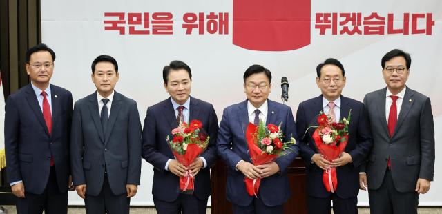 Participants pose for a commemorative photo after Rep Jeong Jeom-sik was elected the new floor leader of the People Power Party during a party lawmakers meeting at the National Assembly in Seoul on June 10 2026 At far left is Rep Yoo Sang-bum who was serving as chair of the partys election committee at the timeYonhap 
