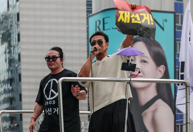 Participants march through the Hongdae area during a rally calling for a presidential election rerun organized by the conservative youth group BOSS Hongdae in Seoul on June 27, 2026. AJP Yoo Na-hyun

