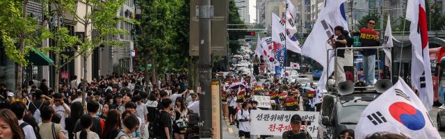Participants march through the Hongdae area during a rally calling for a presidential election rerun organized by the conservative youth group BOSS Hongdae in Seoul on June 27, 2026. AJP Yoo Na-hyun


