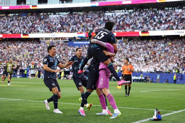 Paraguay players embrace goalkeeper Orlando Gill after beating Germany in a penalty shootout in their 2026 FIFA World Cup round-of-32 match at Boston Stadium in Foxborough Massachusetts on June 29 2026 AFPYonhap