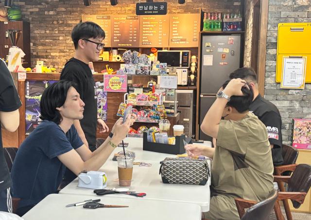 범계동의 한 카페에서 포켓몬 카드 수집가들이 카드 거래를 하고 있다 사진한준구 기자