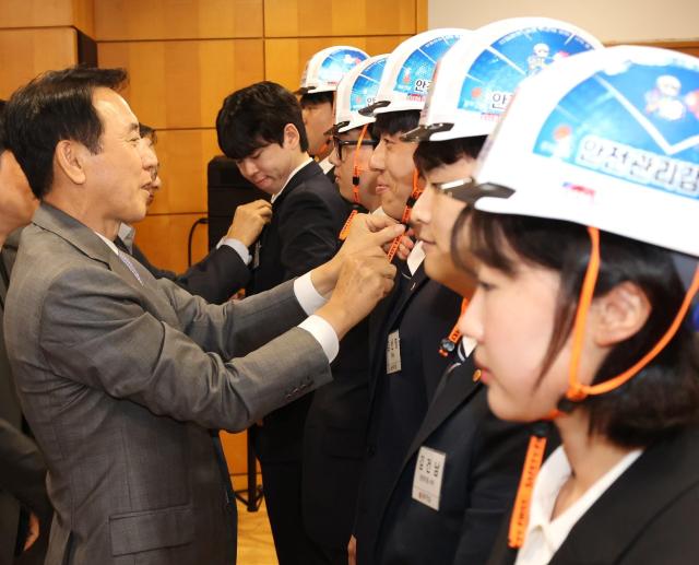 윤진오 동부건설 대표이사가 신입사원에게 안전모를 수여하고 있다 사진동부건설