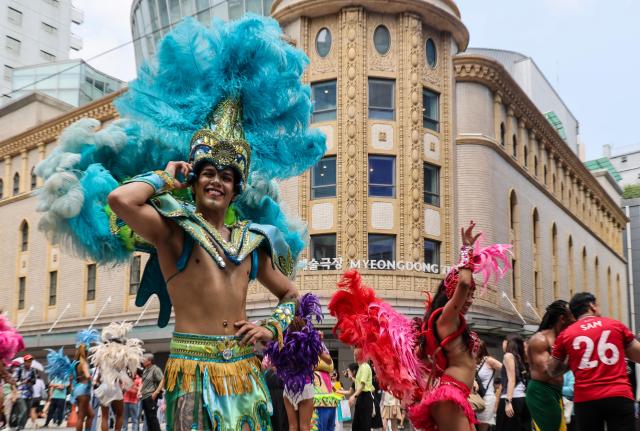 Lotte World Adventure performers stage a samba performance to celebrate the opening of the theme parks summer festival on UNESCO Street in Seouls Myeong-dong district on July 1 2026 AJP Yoo Na-hyun