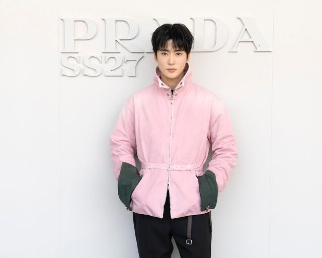 NCTs Jaehyun attends the Prada SpringSummer 2027 show wearing a pink jacket and black trousers from the collection Courtesy of PRADA