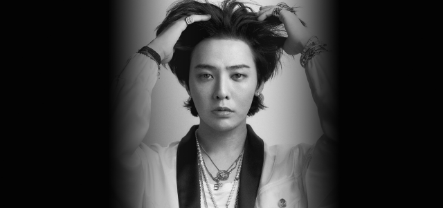 A black-and-white portrait of G-Dragon captured from Galaxy Corporations official website