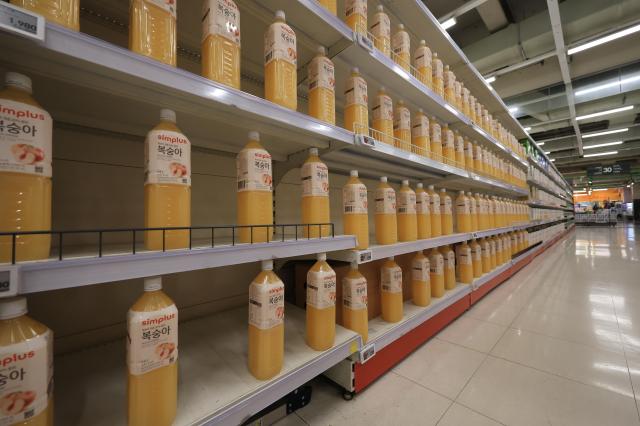 Bottles of juice are sparsely lined on shelves at a Homeplus store in Map District Seoul on July 3 2026 AJP Han Jun-gu