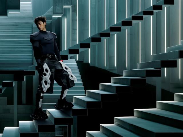 A teaser image for Yunhos single Times Tickin shows him in an armored game-character-style outfit against a digital cityscape backdrop a wristwatch visible on his raised arm Courtesy of SM Entertainment 
