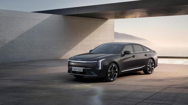 A Kia sedan is shown parked outside a modern minimalist building overlooking the coast in a promotional image showcasing the brands design Courtesy of Hyundai Motor Group