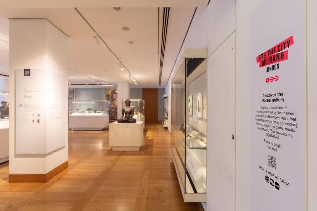 The entrance to the British Museums Korea Foundation Gallery Room 67 with signage for BTS THE CITY ARIRANG LONDON and a QR code directing visitors to the Korea Gallery Trail in London Courtesy of HYBE Entertainment 