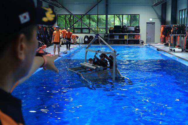 Firefighters from the Gyeonggido Special Rescue Service conduct emergency water survival training at the Gyeonggi Fire Academy rescue training facility in Yongin Gyeonggi Province on July 8 2026 AJP Han Jun-gu