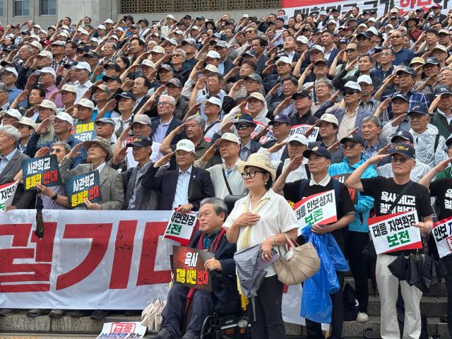 Participants salute during a rally against the proposed merger of South Korea’s military academies and the relocation of the Korea Military Academy in front of the National Assembly in Seoul on July 8 2026 AJP Kim Hee-su