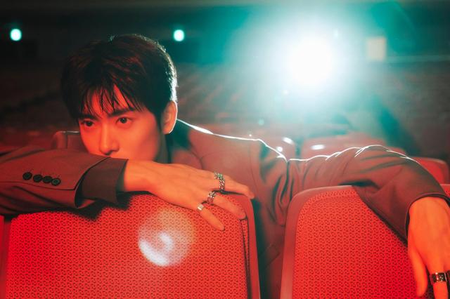 NCTs Jaehyun in a still from the music video teaser for his solo single 99 Degrees set in a theater Courtesy of SM Entertainment 