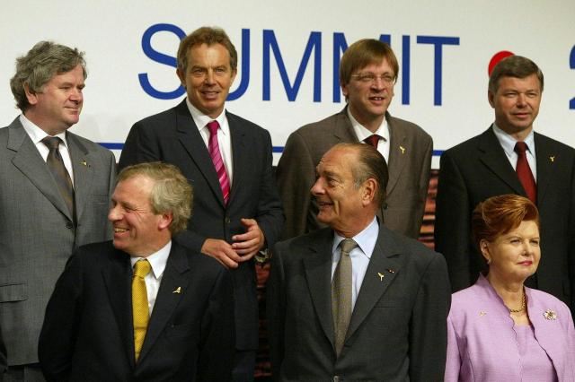 NATO Heads of State and Government along with the NATO Secretary General laugh as they line up for the family photo Courtesy of NATO 