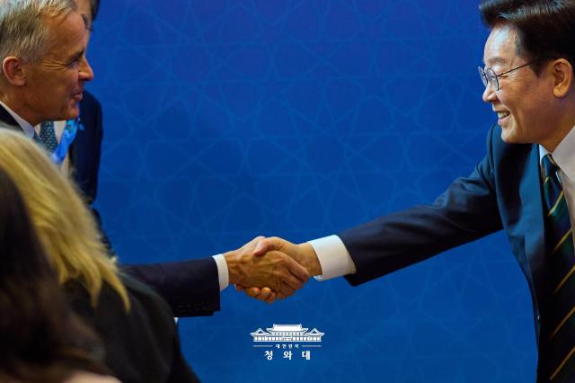 South Korean President Lee Jae Myung right shakes hands with Canadian Prime Minister Mark Carney before their summit at the Ankara Convention Center in Ankara Turkey on July 7 2026 Courtesy of the Presidential Office 