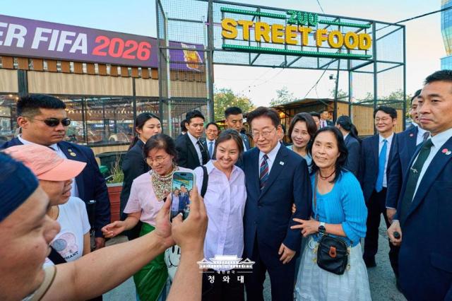 President Lee Jae Myung center and first lady Kim Hea Kyung meet with people in Ulaanbaatar Mongolia on July 9 2026 Courtesy of Cheong Wa Dae