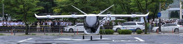 Visitors wait for the start of the Urban Air Mobility UAM Flight Showcase during the 2026 Korea Drone  UAM Expo at the INU Innovation Center of the University of Incheon in Incheon on July 15 2026 AJP Yoo Na-hyun