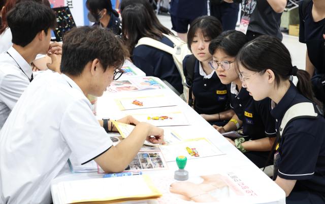A child takes part in an activity at a booth operated by youth participants during the 2026 Seoul Career and Vocational Expo at the aT Center in Yangjae Seoul on July 16 2026 AJP Yoo Na-hyun