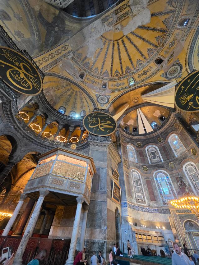 The sultans loge and a giant calligraphic roundel bearing the name of the Prophet Muhammad are seen inside Hagia Sophia in Istanbul on July 17 2026 White curtains upper right cover the ninth-century Byzantine mosaic of the Virgin and Child in the apse a practice adopted after the building returned to use as a mosque in 2020 Built as a cathedral in 537 Hagia Sophia has also served as a mosque and a museum over its history AJP Park Sae-jin