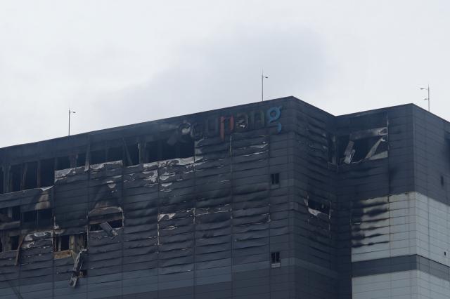 A close-up view of the fire-scarred upper floors of the Coupang warehouse their walls blackened and windows blown out AJP Han Jun-gu