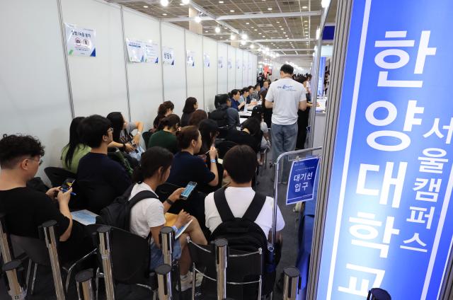 Applicants and parents wait for counseling at the 2027 Early Admissions Fair held at COEX in Gangnam-gu Seoul July 23 2026 AJP Han Jun-gu