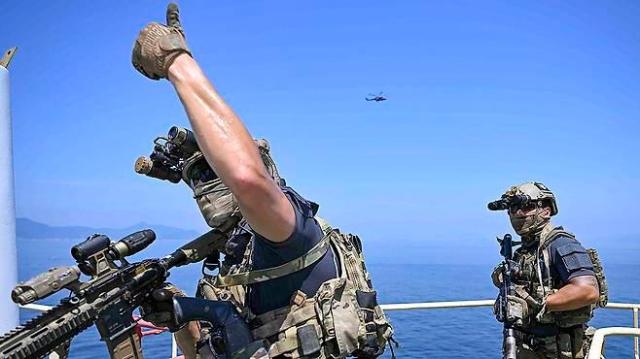 Members of a boarding search team from Cheonhae Unit search the interior of a vessel simulating a hijacked merchant ship during a counter-piracy exercise Courtesy of the ROK Navy