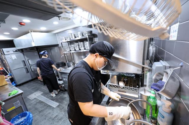 Employees wash dishes at Youth Mungans Nakseongdae branch in Gwanak District Seoul on July 20 2026 AJP Yoo Na-hyun