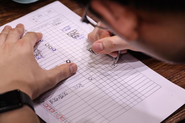 Employee Kim Ji-woo fills out a daily work log after completing his shift at Youth Mungans Nakseongdae branch in Gwanak District Seoul on July 20 2026 AJP Yoo Na-hyun