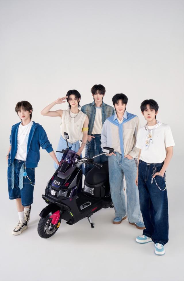Members of JYP Entertainments China-based boy group CIIU pose with a Xinri electric scooter after being selected as advertising models for the Chinese electric bicycle brand Courtesy of JYP Entertainment China