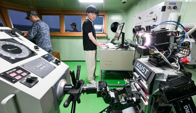 Humanoid robot PIBOT steers a ship during a Navy combat trial on July 23 Courtesy of the Republic of Korea Navy