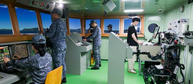 Humanoid robot PIBOT steers a ship during a Navy combat trial on July 23 Courtesy of the Republic of Korea Navy
