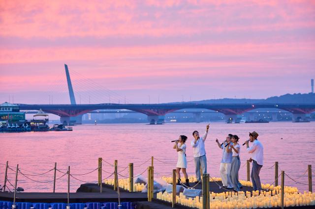 Performers sing on a candlelit waterfront stage along the Han River in Seoul Courtesy of the Seoul Metropolitan Government