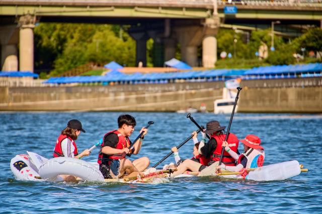 Participants paddle a homemade raft during a water recreation program on the Han River in Seoul Courtesy of the Seoul Metropolitan Government