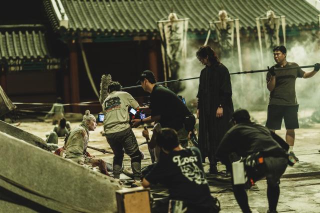 Crew members can be seen as they film a scene on the set of Netflixs The East Palace Courtesy of Netflix