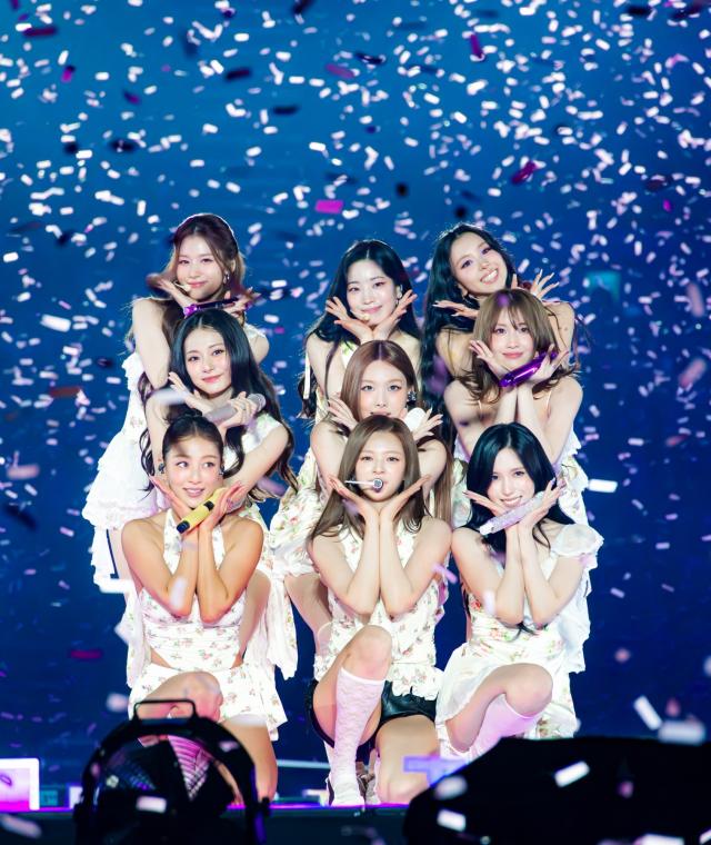 Members of TWICE pose onstage during the finale concert of the groups THIS IS FOR world tour at KSPO Dome in Seoul Courtesy of JYP Entertainment