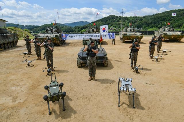 Soldiers salute alongside unmanned systems including quadruped robots and drones during a launch ceremony for an experimental manned-unmanned squad at the 11th Maneuver Division’s Cheolma Unit in Hongcheon Gangwon Province July 29 2026 Courtesy of the Army