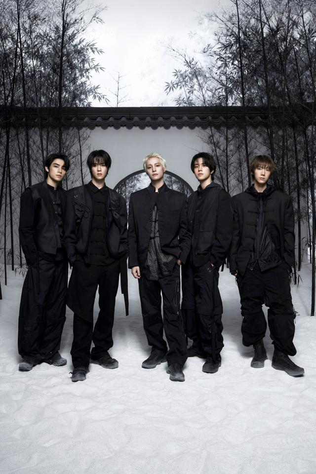 Members of Chinese boy band WayV dressed in matching black outfits stand before a circular moon gate framed by bare bamboo in a teaser image for the groups eighth EP Vision Wings released by SM Entertainment Courtesy of SM Entertainment