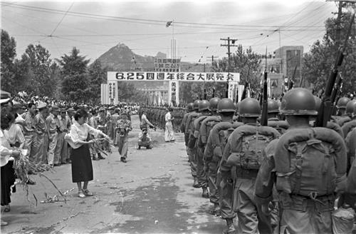 South Korean soldiers take part in a street parade marking the fourth anniversary of the outbreak of the Korean War on June 25 1954 as civilians line the route The photo was taken by the late Lt Col Han Dong-mok Courtesy of the ROK Army