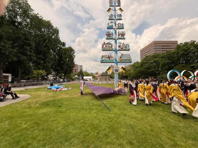 Performers in traditional costume take part in a festival near a maypole-style monument in Odori Park Japan AJP Joonha Yoo