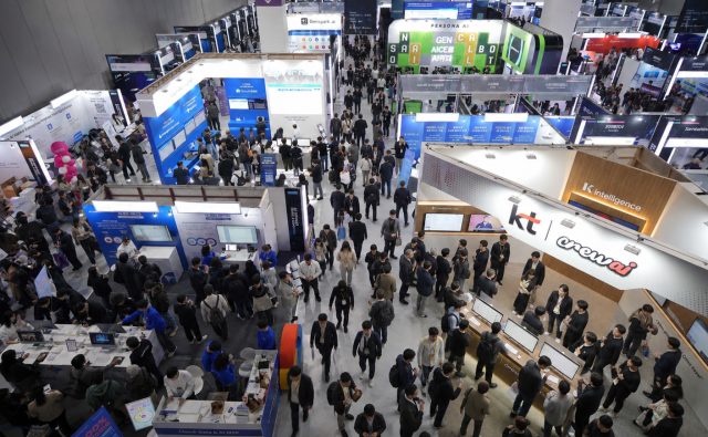 Visitors browse exhibitor booths including Gensparkai and KTs K intelligence at AI Summit Seoul  Expo 2025 held at COEX in southern Seoul in November 2025 Courtesy of COEX