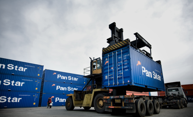 A PanStar-branded shipping container is loaded onto a truck at a cargo terminal in this undated photo provided by PanStar Group Courtesy of PanStar Group