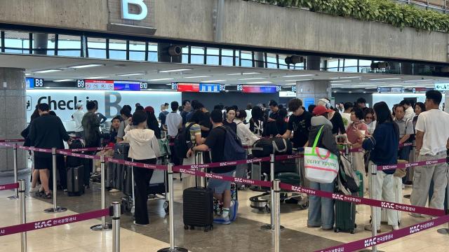 Travelers line up at check-in counters at Gimpo International Airport in Seoul on Aug 12 2026 AJP Kim Hee-su
