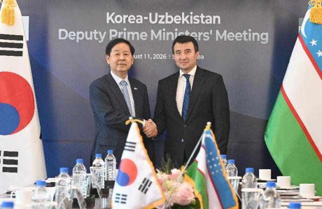 Deputy Prime Minister and Minister of Finance and Economy Koo Yun-cheol left shakes hands with Uzbek Deputy Prime Minister Jamshid Khodjaev before their meeting at Lotte Hotel Seoul on Aug 11 2026 Courtesy of Koreas Ministry of Finance and Economy