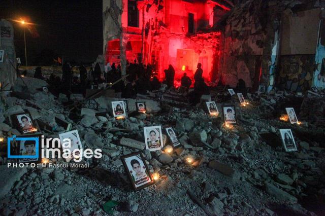 Photographs of victims are placed outside a residential building damaged in strikes on Iran Courtesy of the Embassy of the Islamic Republic of Iran in Seoul