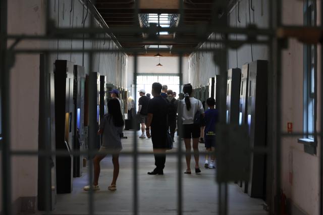 Visitors tour the inside of a cell block at Seodaemun prison history hall in Seoul August 14 2026 AJP Han Jun-gu