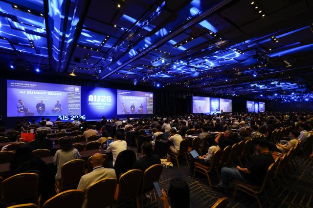 Speakers take part in a panel discussion during the AI Summit Seoul conference at COEX's Grand Ballroom in southern Seoul on Wednesday. The two-day conference, part of AISE 2026, runs through Thursday with 69 expert sessions on topics including AI agents, manufacturing and physical AI. Courtesy of COEX