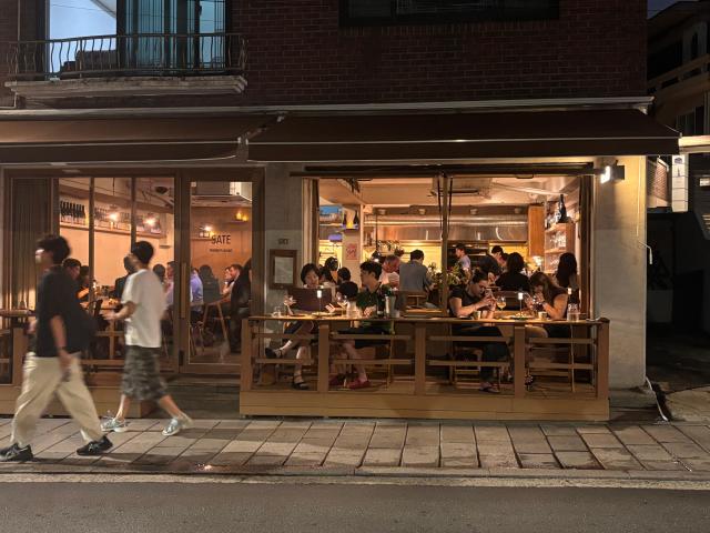 Diners fill a restaurant along a street in Haebangchon Yongsan District central Seoul on Aug 20 2026 AJP Ryu Yuna