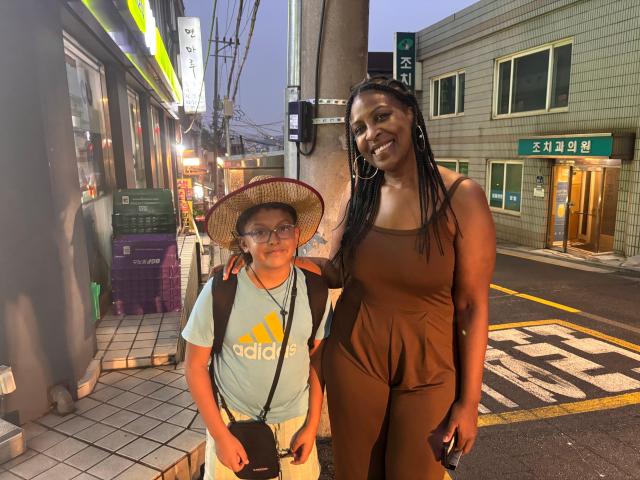 Aurelia Rhinan 38 a visitor from France poses with her nephew in Haebangchon Yongsan District central Seoul on Aug 20 2026 AJP Ryu Yuna