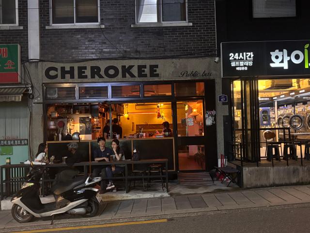 People sit outside a bar in Haebangchon Yongsan District central Seoul on Aug 20 2026 AJP Ryu Yuna